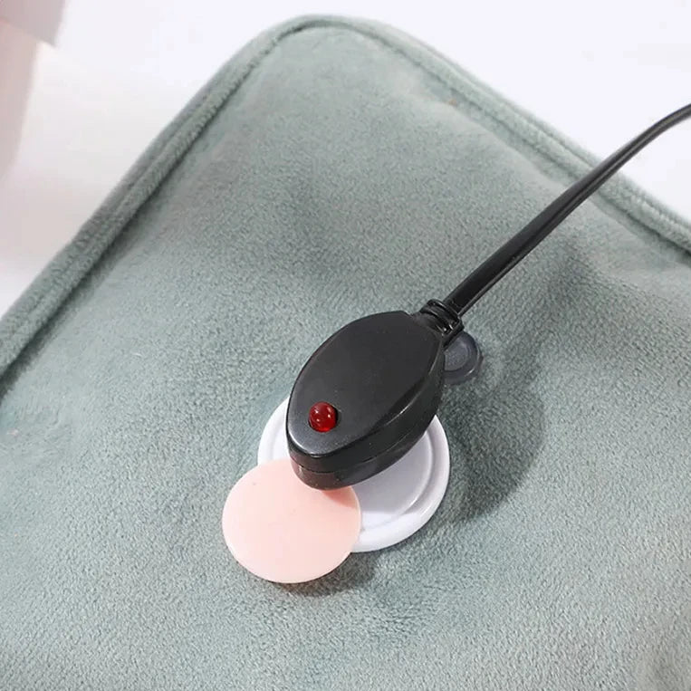 Small electronic device with a pink ball on a gray surface